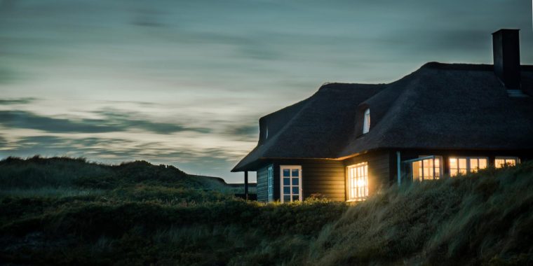 House at night with light shining.