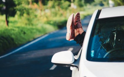 Feet out of car window.