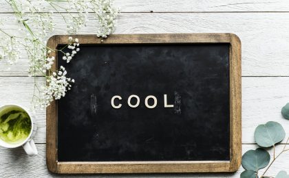 The word "cool" on a black board.