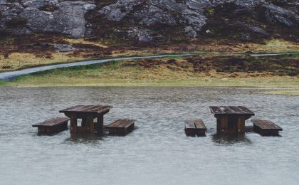 Picnic tables in flood waters.