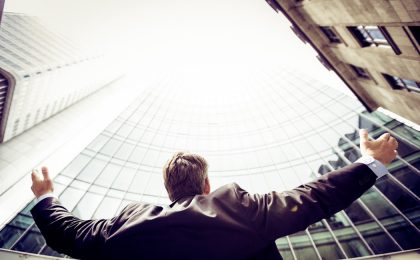 Man looking up at buildings.