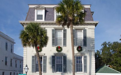 Palm tree in front of a lovely Charleston home.