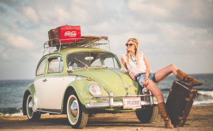 Woman posing with car that doesn't need full coverage.