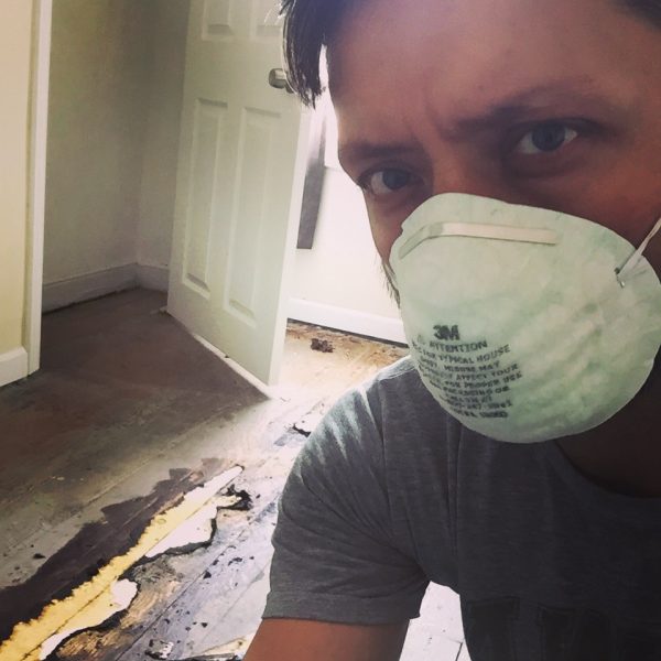 Man with mask redoing floors.