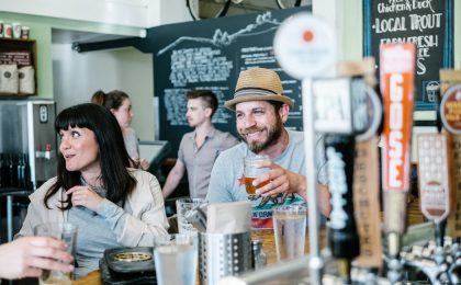 Guy drinking at a brewery.