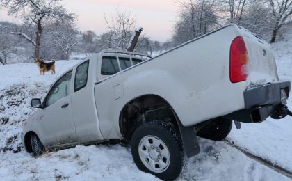 Truck wrecked in a snow bank.