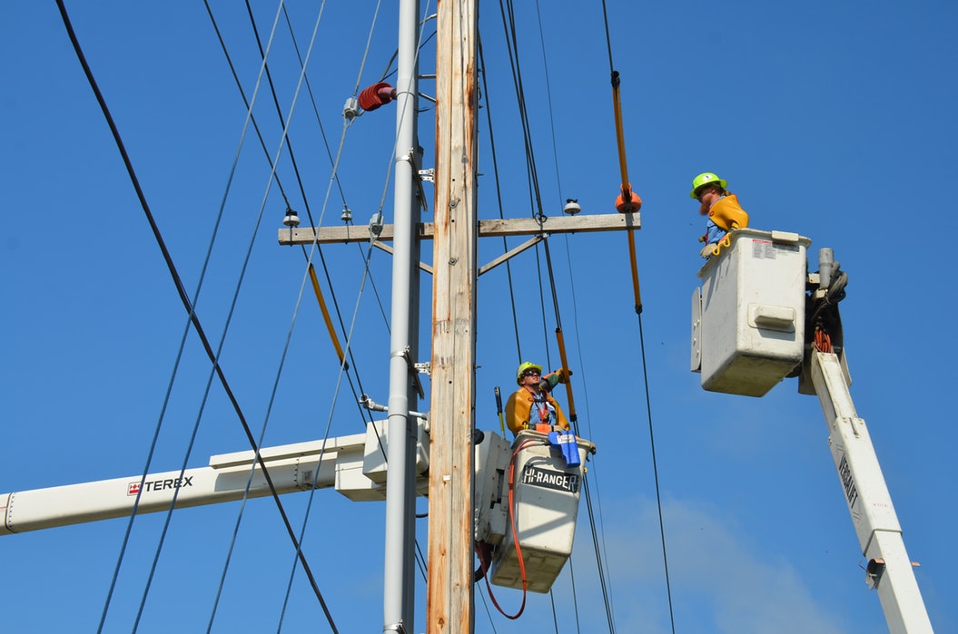 Electrical workers on power lines.