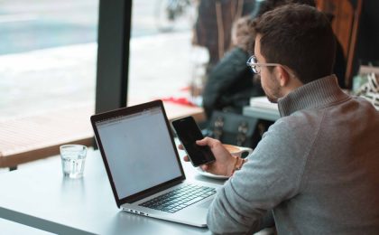 Man at cafe with computer.