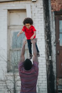 Baby lifted by Daddy.