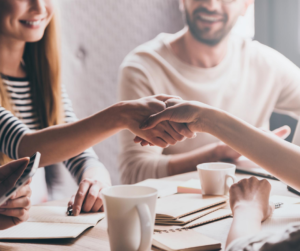 Family settling a claim with an adjuster over a handshake.