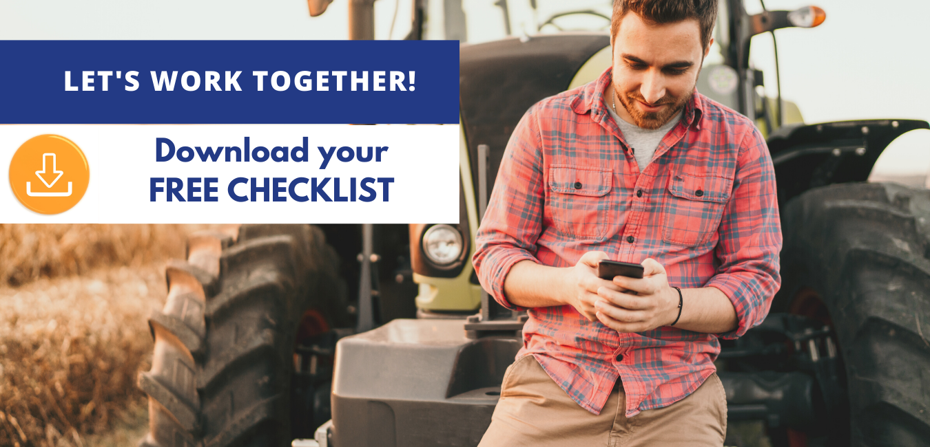 Farmer leaning against a tractor while downloading a free farm checklist on his phone.