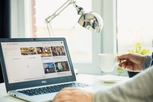 Airbnb host insurance. Modern laptop on the desk with Airbnb website on the screen.