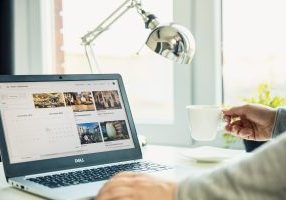 Airbnb host insurance. Modern laptop on the desk with Airbnb website on the screen.